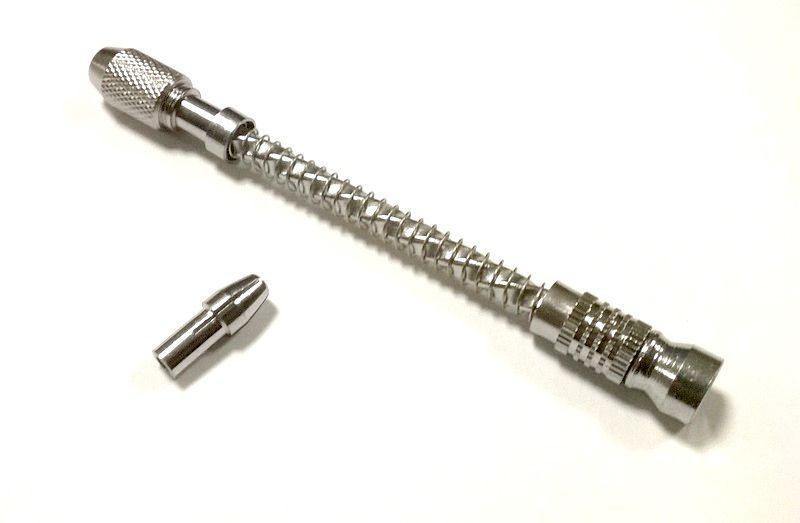 Hand drill with spring return